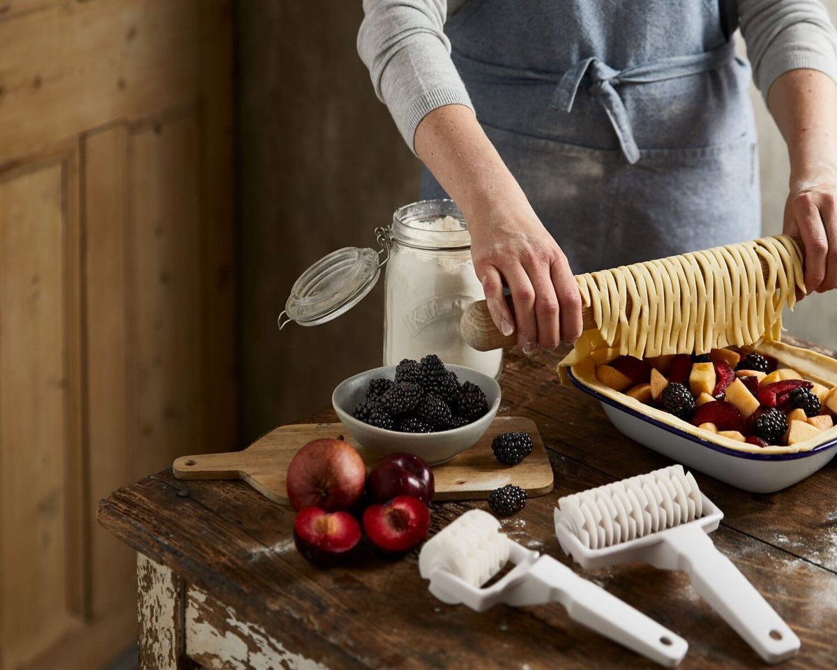 Woman baking and making autumn recipes lattice fruit pie