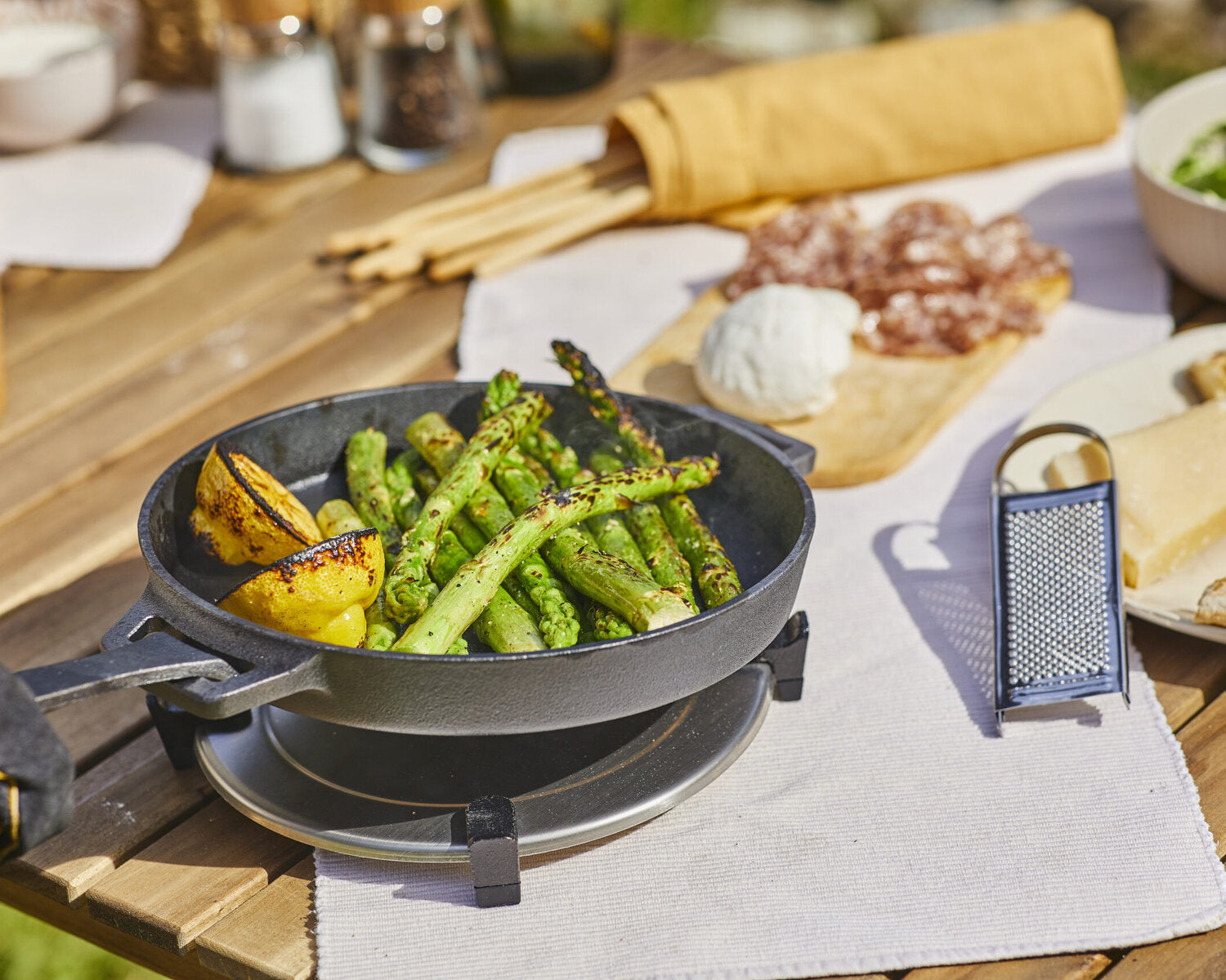 Ooni skillet for cooking veggie ooni recipes with roasted potatoes and asparagus inside