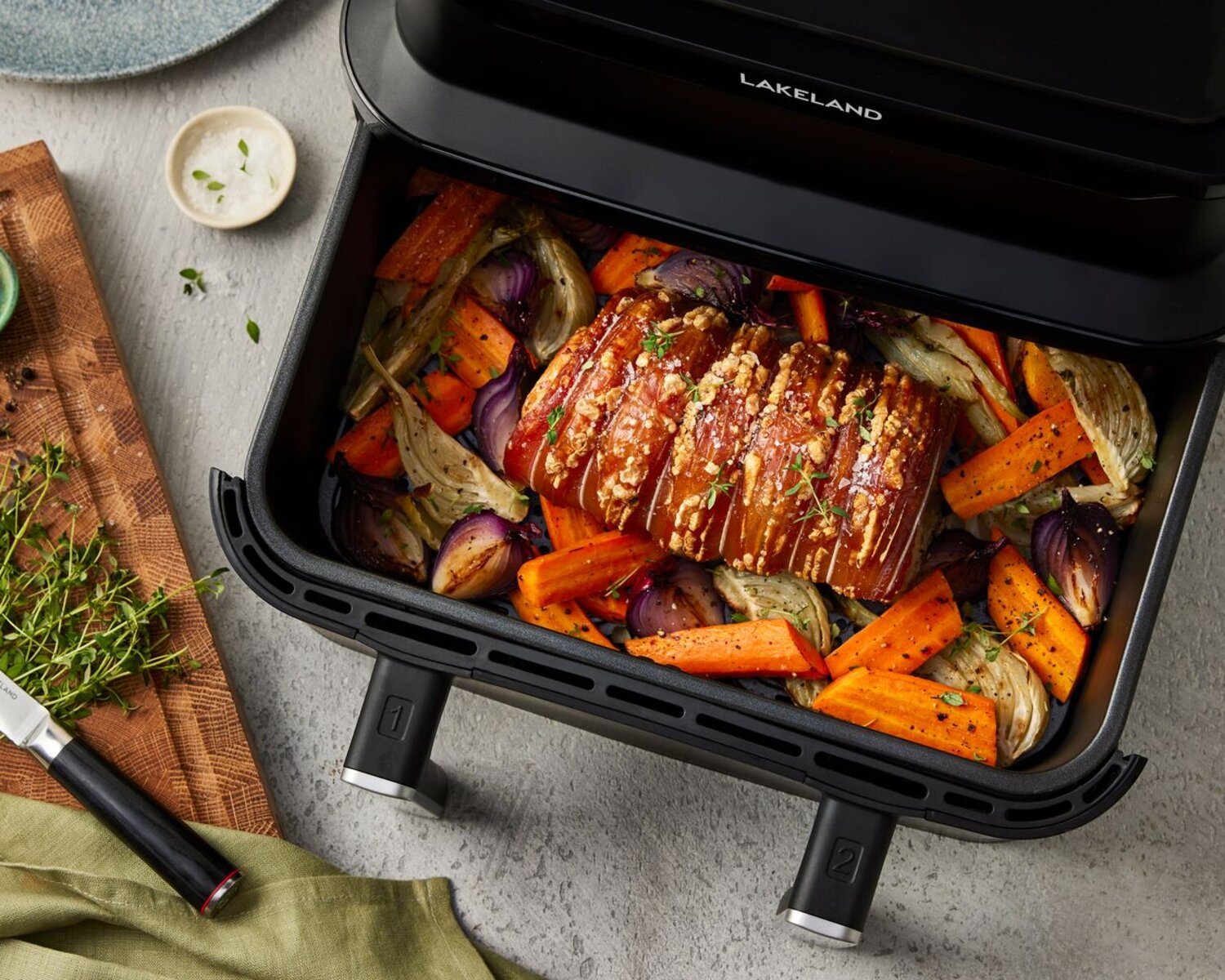 Roast dinner with carrots, veg and pork joint being cooked in an air fryer