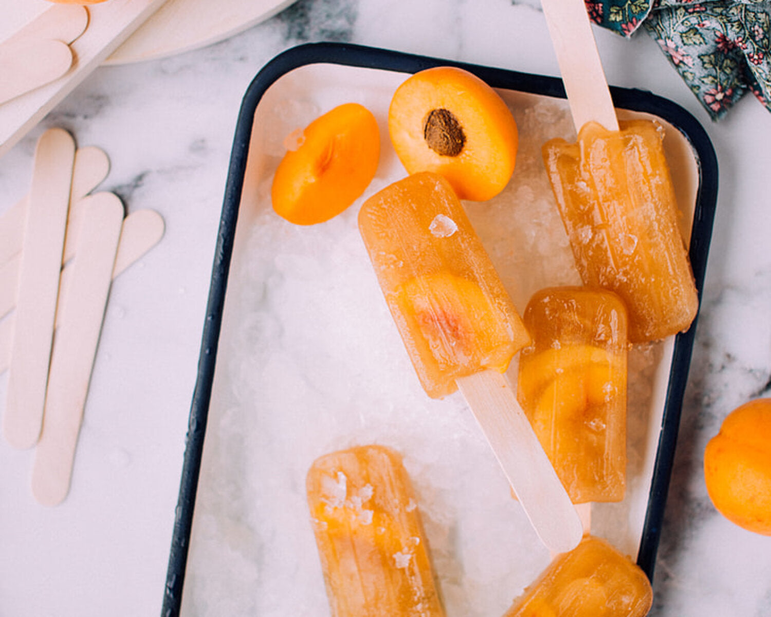 Homemade ice lollies on top of tray on kitchen countertop