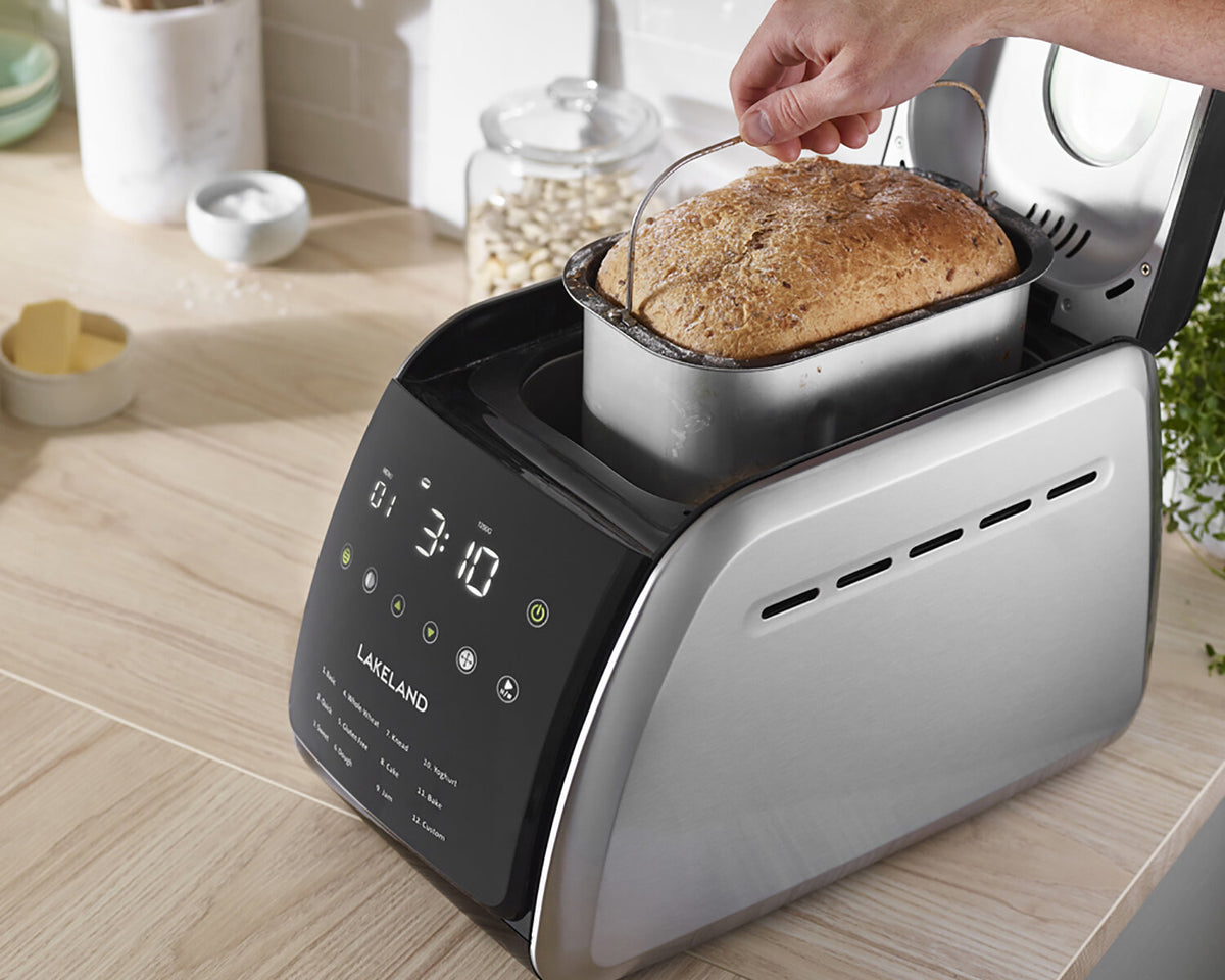 bread loaf being taken out of the Lakeland touchscreen bread maker