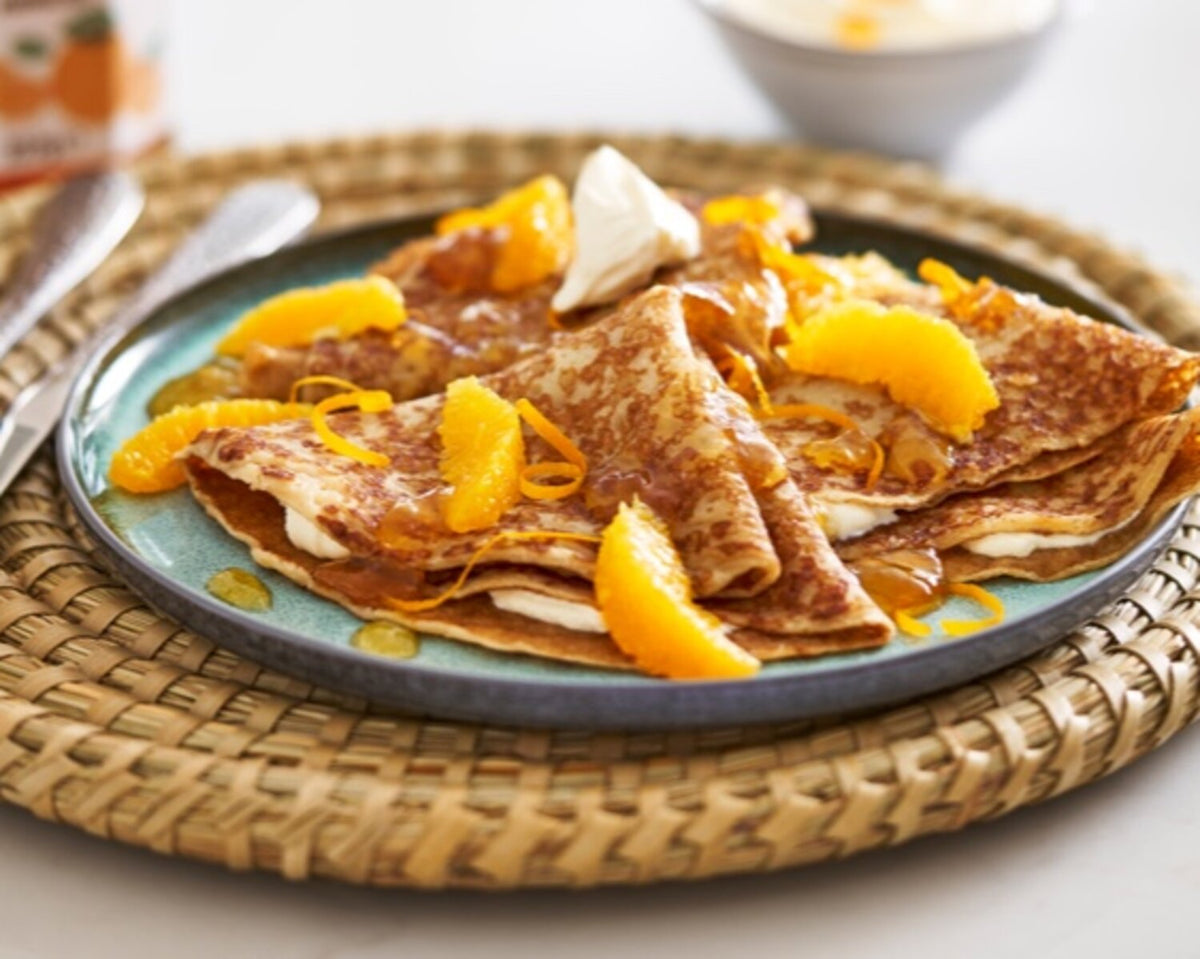 Pancake day image of thin crepes with orange