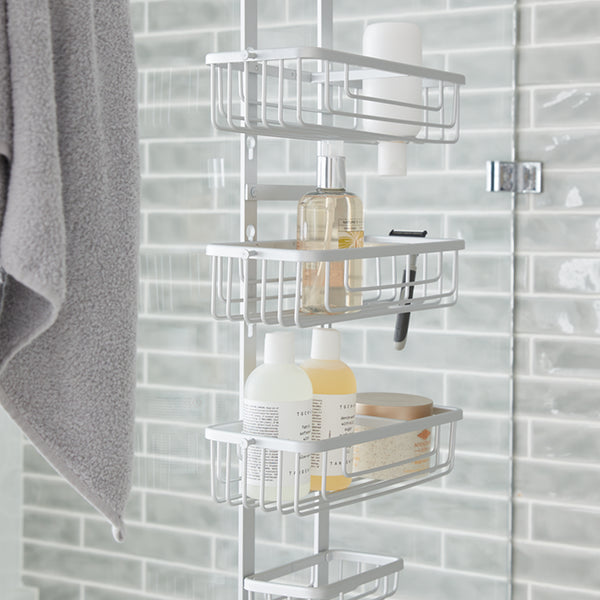 A Lakeland shower caddy holding bathroom essentials, is hanging in a shower.