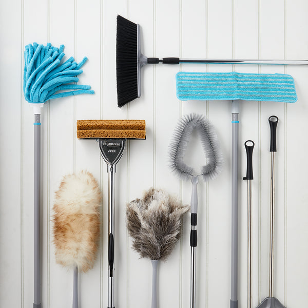 A collection of Lakeland brushes and dusters on a flat surface.