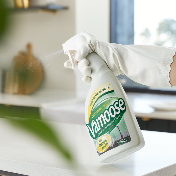 Vamoose Kitchen Cleaner being sprayed on a surface.