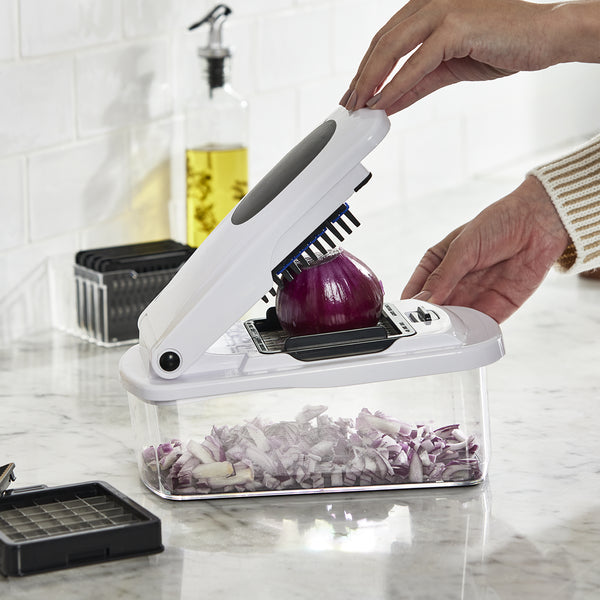 A Lakeland multi-chop gadget is being used to dice a red onion.