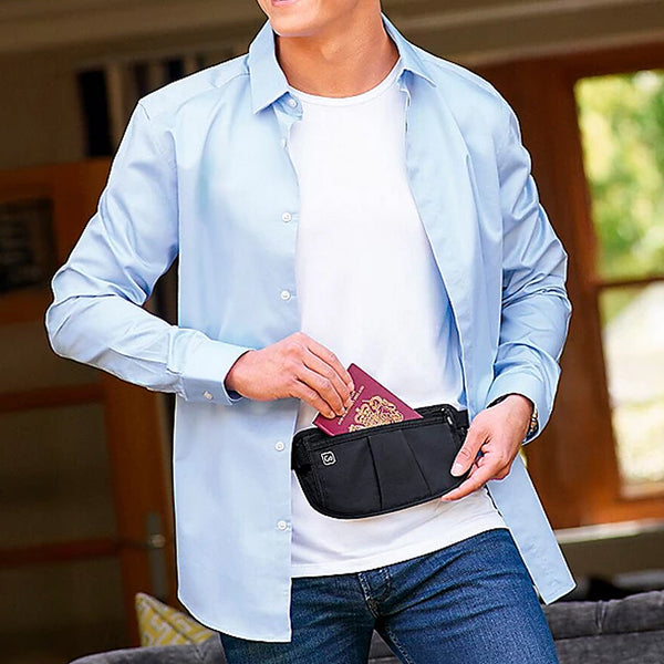 A man retrieving his passport from a convenient passport bag stapped around his waist.